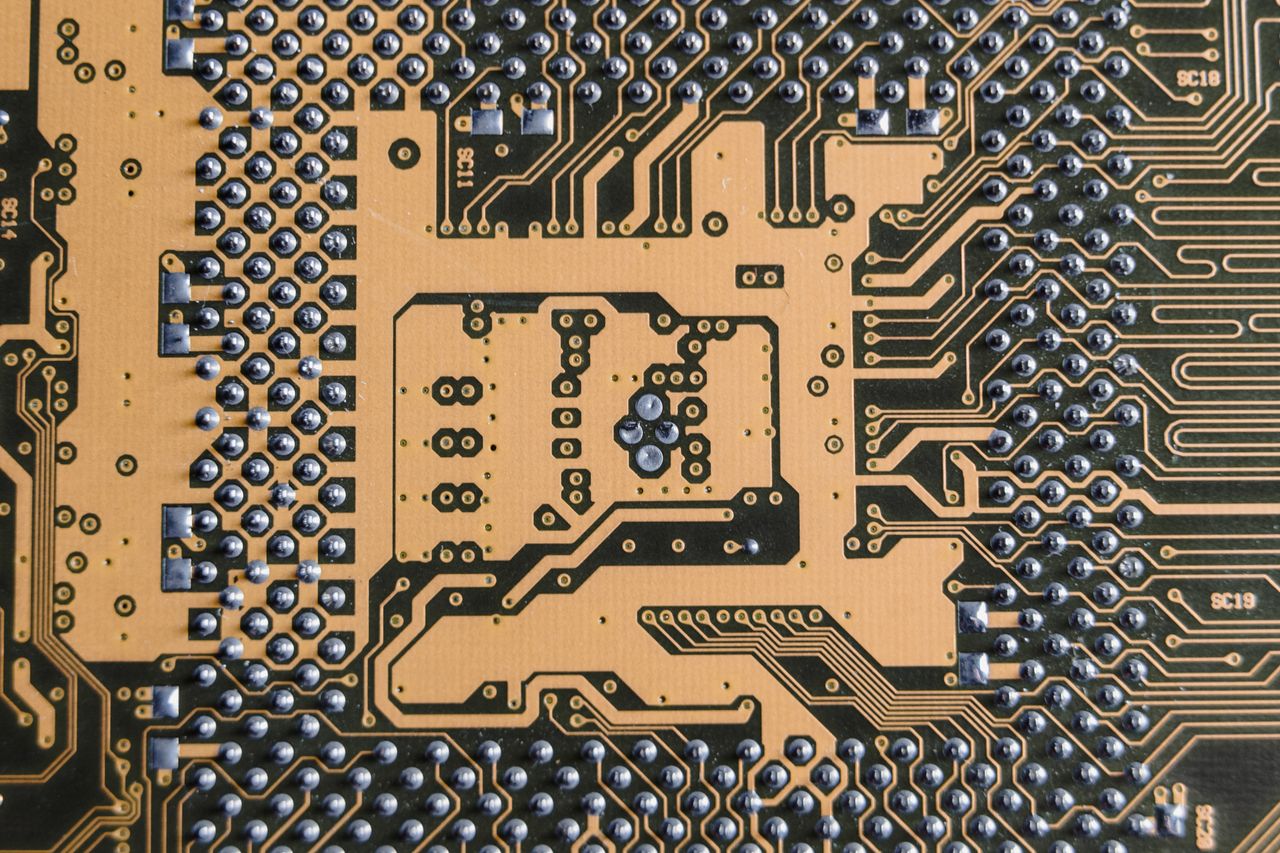 The Art of Drawing Readers In: Your attractive post title goes here Detailed view of a circuit board showcasing intricate patterns and metallic connections.